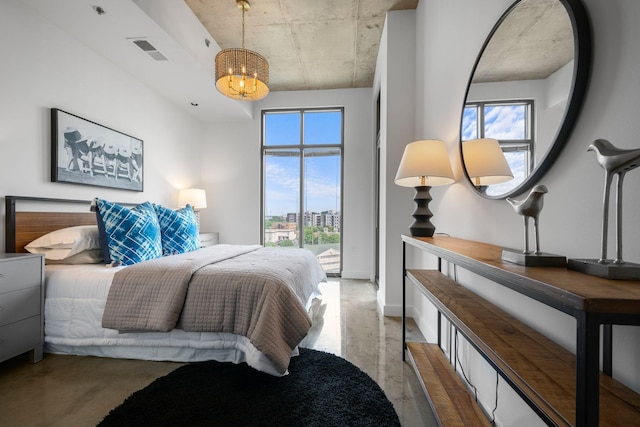 1510 Demonbreun St Unit 712, Nashville, TN 37203 - bedroom featuring multiple windows, a chandelier, and finished concrete floors