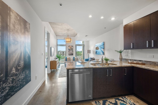 1510 Demonbreun St Unit 712, Nashville, TN 37203 - kitchen with stainless steel dishwasher, a sink, a peninsula, light stone countertops, and light wood-type flooring