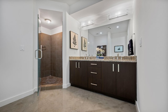 1510 Demonbreun St Unit 712, Nashville, TN 37203 - full bathroom featuring baseboards, concrete flooring, a stall shower, and double vanity