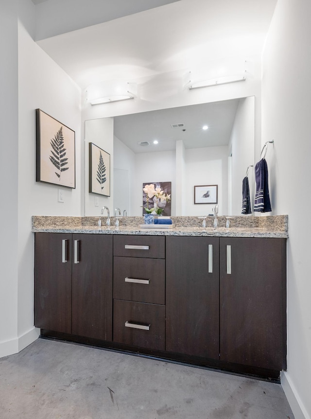 1510 Demonbreun St Unit 712, Nashville, TN 37203 - full bath with concrete flooring, baseboards, and double vanity