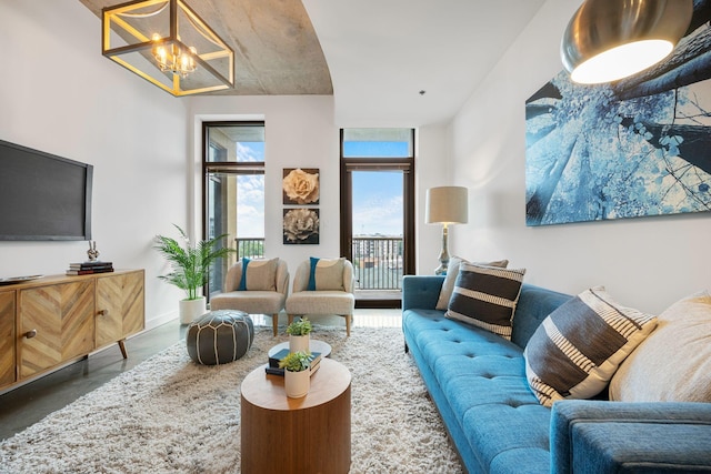 1510 Demonbreun St Unit 712, Nashville, TN 37203 - living area featuring a chandelier and finished concrete flooring
