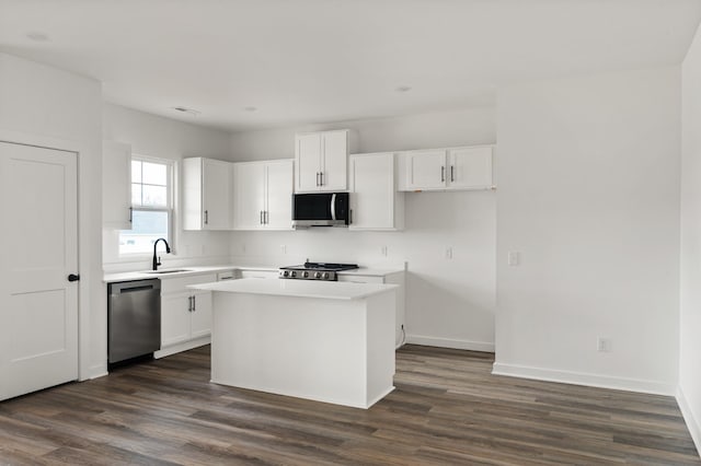 2384 Nelson Way, Cookeville, TN 38506 - kitchen with stainless steel appliances, white cabinetry, dark wood finished floors, a kitchen island, and light countertops