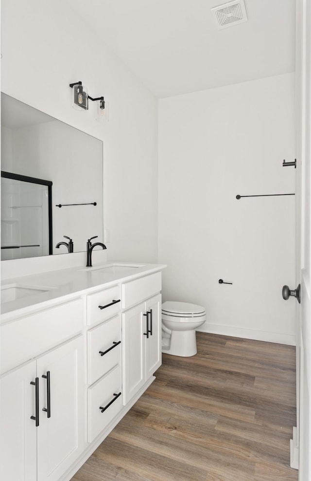 2384 Nelson Way, Cookeville, TN 38506 - full bath featuring double vanity, wood finished floors, toilet, and baseboards