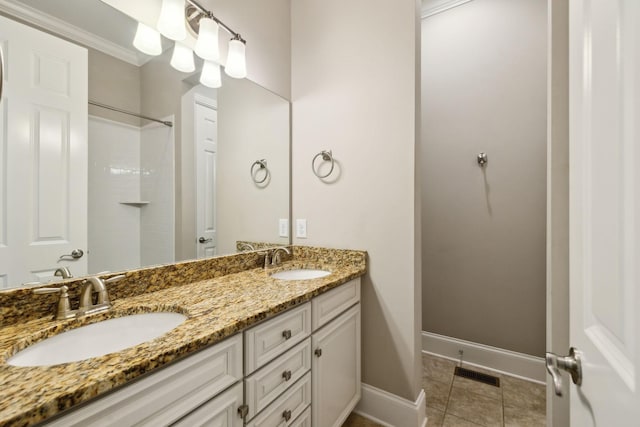 4101 Owen Watkins Ct, Franklin, TN 37067 - bathroom with double vanity, baseboards, a shower, tile patterned floors, and crown molding