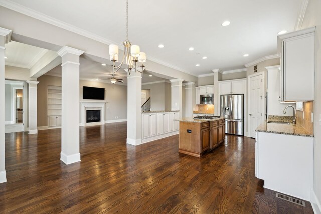 4101 Owen Watkins Ct, Franklin, TN 37067 - kitchen with appliances with stainless steel finishes, a sink, recessed lighting, a fireplace, and a kitchen island