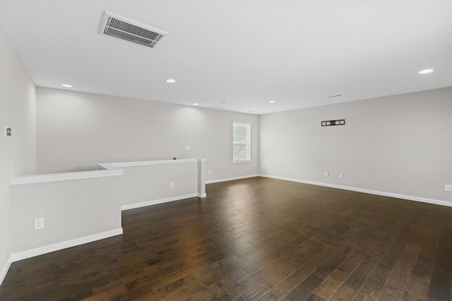 unfurnished room featuring dark wood-style floors, recessed lighting, and baseboards