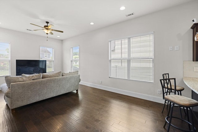 living room featuring a ceiling fan, baseboards, dark wood-style floors, and recessed lighting