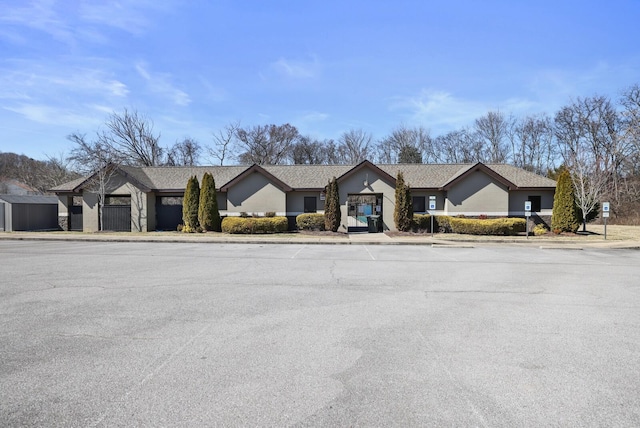 ranch-style house with uncovered parking
