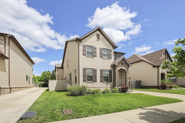 view of front of house featuring driveway and brick siding