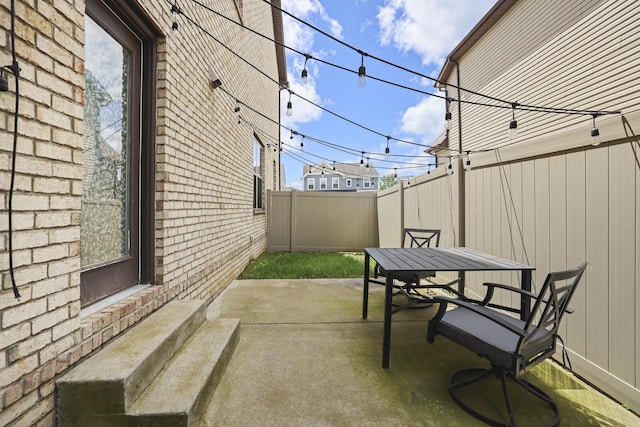 view of patio featuring fence, outdoor dining area, and entry steps