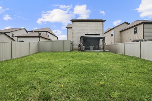 back of house featuring brick siding and a gazebo