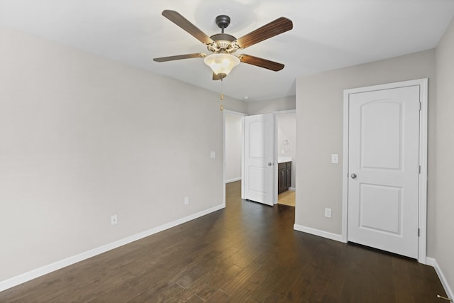 unfurnished bedroom with baseboards, dark wood-type flooring, and a ceiling fan