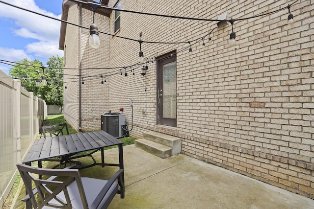 view of patio / terrace with entry steps, outdoor dining area, and cooling unit