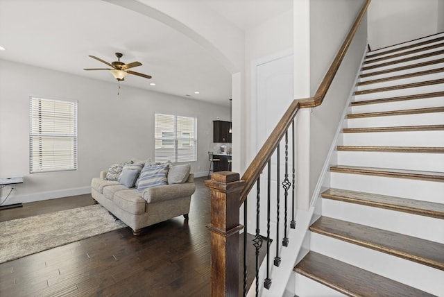 living room with a ceiling fan, arched walkways, wood finished floors, recessed lighting, and stairs