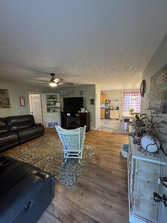 162 Pigeon Roost Rd, Brush Creek, TN 38547 - living area with a ceiling fan, wood finished floors, and a textured ceiling