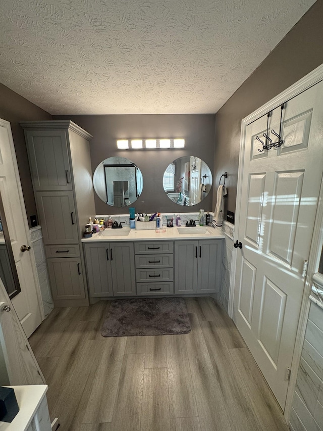 162 Pigeon Roost Rd, Brush Creek, TN 38547 - full bathroom featuring wood finished floors, a textured ceiling, and double vanity