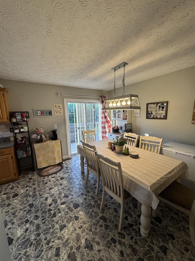 162 Pigeon Roost Rd, Brush Creek, TN 38547 - dining space with stone floors and a textured ceiling