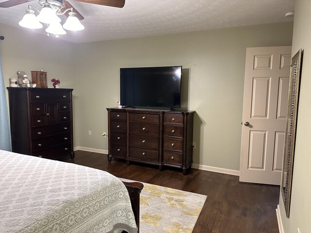 434 Hickman Shores Rd, Dover, TN 37058 - bedroom with dark wood-style floors, baseboards, a textured ceiling, and ceiling fan