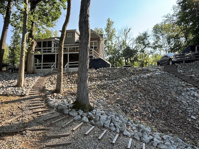 434 Hickman Shores Rd, Dover, TN 37058 - back of property featuring stairway, a wooden deck, and a sunroom
