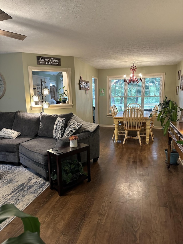 434 Hickman Shores Rd, Dover, TN 37058 - living area featuring a textured ceiling, dark wood-style floors, a chandelier, and baseboards