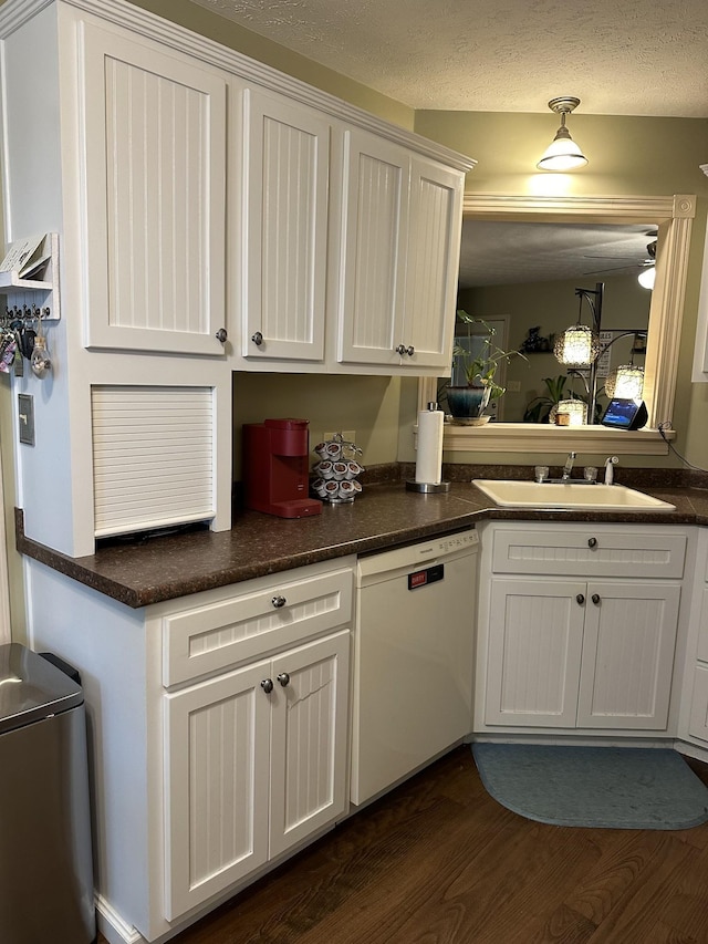 434 Hickman Shores Rd, Dover, TN 37058 - kitchen featuring white dishwasher, a sink, dark wood-style floors, white cabinetry, and dark countertops