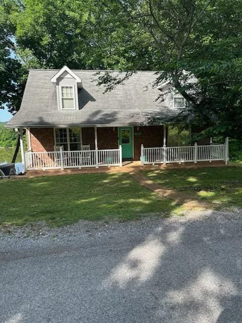 434 Hickman Shores Rd, Dover, TN 37058 - view of front of property featuring a porch, a front yard, and brick siding