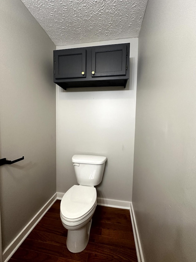1321 Rickman Rd, Livingston, TN 38570 - bathroom with wood finished floors, toilet, baseboards, and a textured ceiling