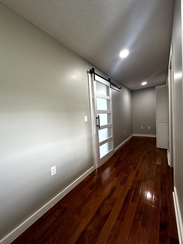 1321 Rickman Rd, Livingston, TN 38570 - spare room with a barn door, dark wood-type flooring, baseboards, and recessed lighting
