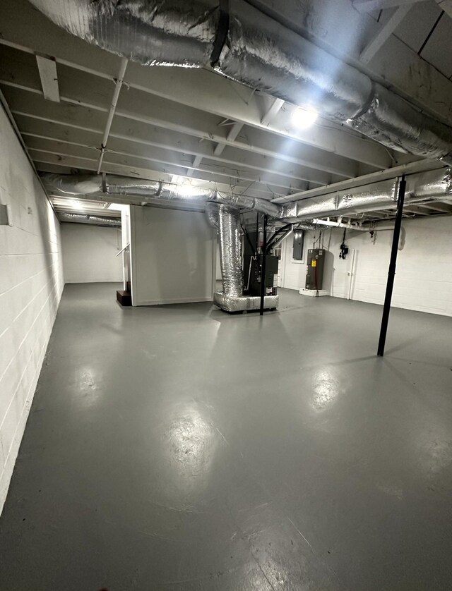 1321 Rickman Rd, Livingston, TN 38570 - unfinished basement featuring water heater, heating unit, electric panel, and concrete block wall