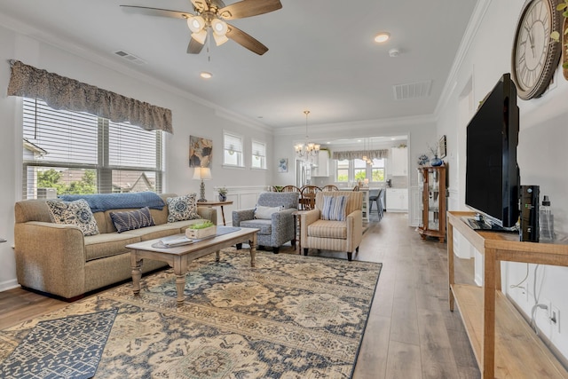 1514 Bledsoe Knl, Spring Hill, TN 37174 - living room with a chandelier, a ceiling fan, light wood-style floors, and ornamental molding