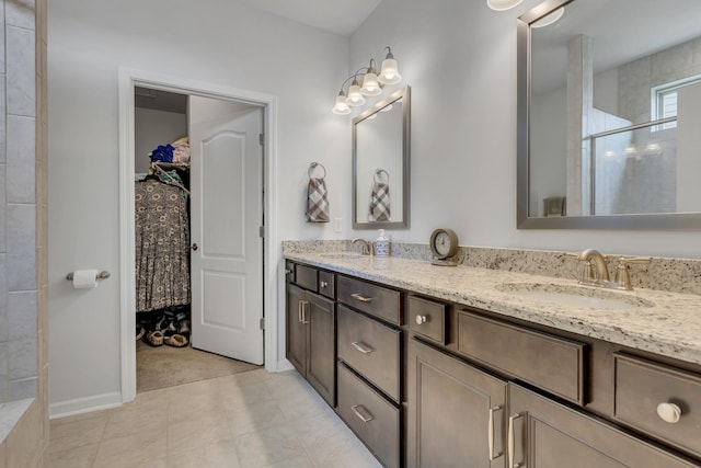 1514 Bledsoe Knl, Spring Hill, TN 37174 - bathroom with tiled shower, double vanity, and a walk in closet
