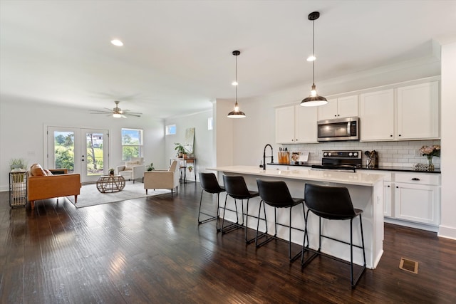 1412 Barrett Dr, Mount Juliet, TN 37122 - kitchen with appliances with stainless steel finishes, decorative backsplash, a breakfast bar, open floor plan, and a ceiling fan