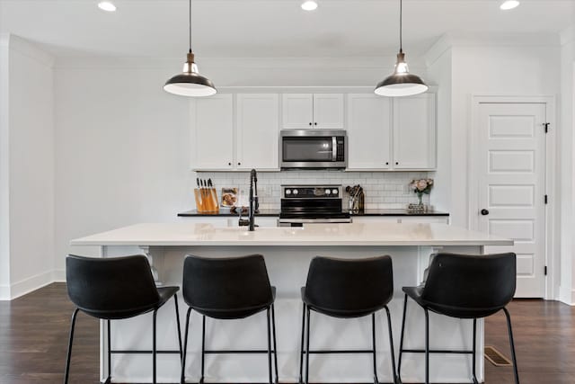 1412 Barrett Dr, Mount Juliet, TN 37122 - kitchen with appliances with stainless steel finishes, tasteful backsplash, dark wood finished floors, recessed lighting, and crown molding
