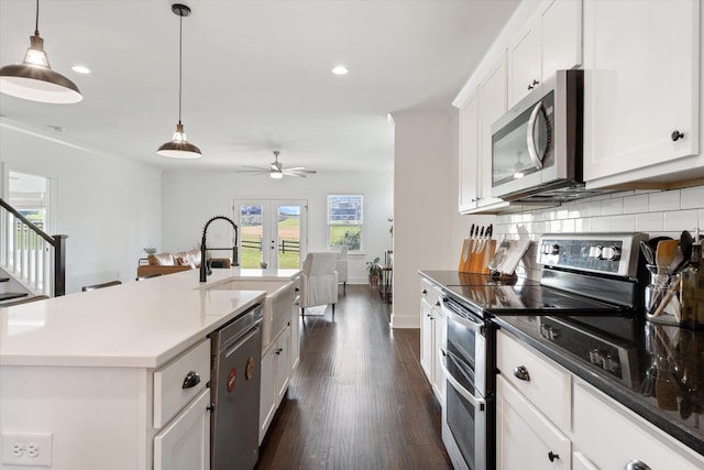 1412 Barrett Dr, Mount Juliet, TN 37122 - kitchen featuring appliances with stainless steel finishes, a sink, french doors, decorative backsplash, and dark wood finished floors