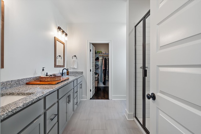 1412 Barrett Dr, Mount Juliet, TN 37122 - bathroom with a stall shower, a spacious closet, double vanity, and baseboards