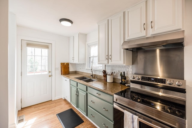 1114 Kingston Springs Rd, Kingston Springs, TN 37082 - kitchen with stainless steel electric range oven, under cabinet range hood, a sink, green cabinetry, and plenty of natural light