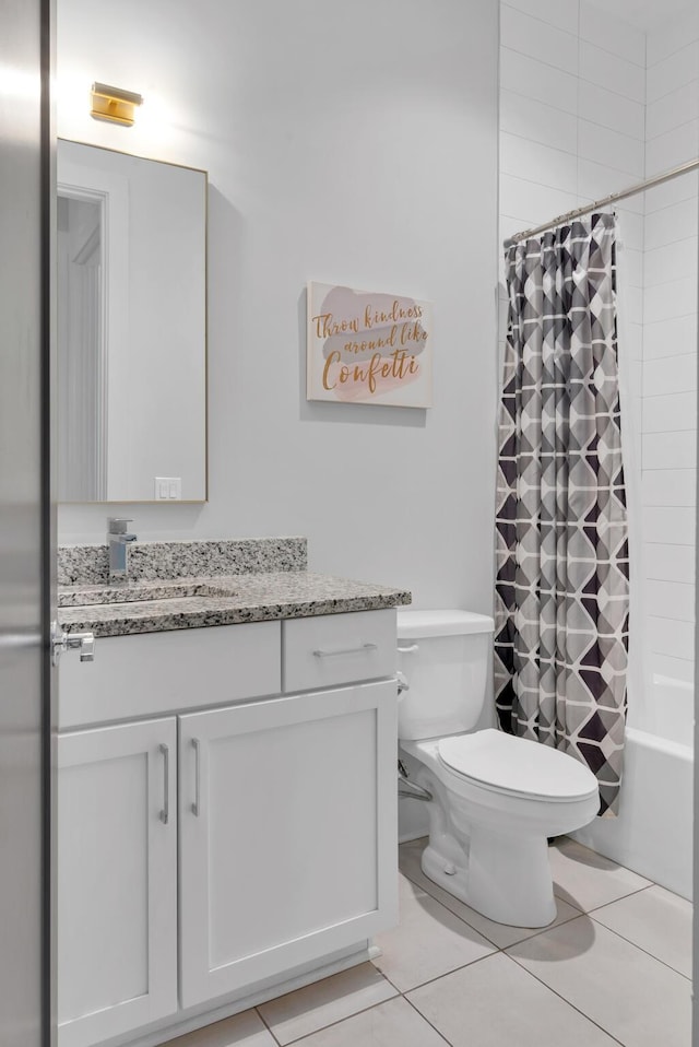 bathroom with vanity, tile patterned floors, toilet, and shower / tub combo
