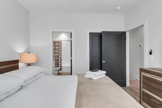 bedroom featuring wood finished floors and a closet