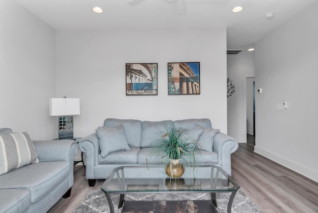 living area with wood finished floors, recessed lighting, baseboards, and ceiling fan