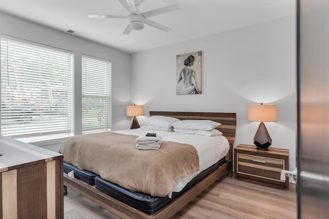 bedroom featuring light wood-style flooring and a ceiling fan