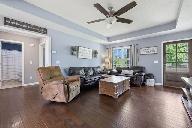 1014 Gill Hodges Rd, Portland, TN 37148 - living room featuring a tray ceiling, a ceiling fan, dark wood-style flooring, and baseboards