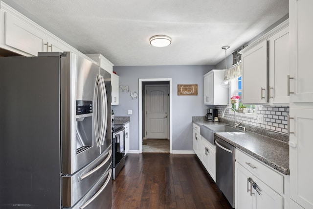 1014 Gill Hodges Rd, Portland, TN 37148 - kitchen featuring stainless steel appliances, a sink, backsplash, white cabinets, and dark wood finished floors