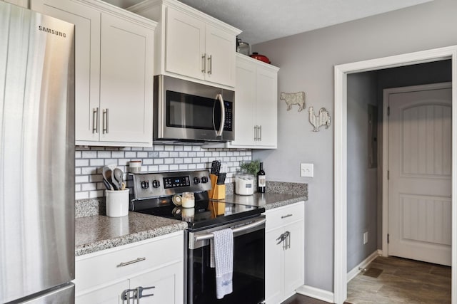 1014 Gill Hodges Rd, Portland, TN 37148 - kitchen featuring appliances with stainless steel finishes, tasteful backsplash, white cabinetry, and dark wood-style flooring