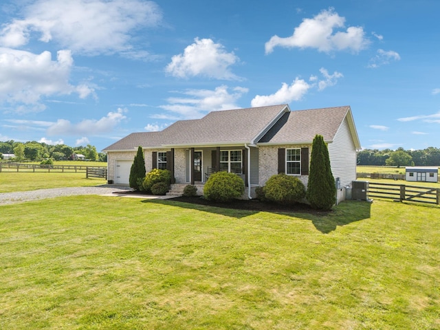 1014 Gill Hodges Rd, Portland, TN 37148 - ranch-style house featuring gravel driveway, an attached garage, covered porch, and brick siding