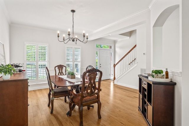 1201 Banbury Row, Brentwood, TN 37027 - dining area featuring light wood finished floors, a chandelier, ornamental molding, arched walkways, and stairway