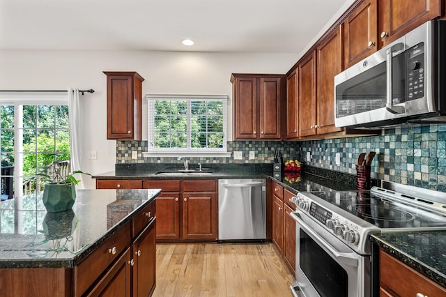 1201 Banbury Row, Brentwood, TN 37027 - kitchen with appliances with stainless steel finishes, a sink, tasteful backsplash, light wood finished floors, and dark stone counters