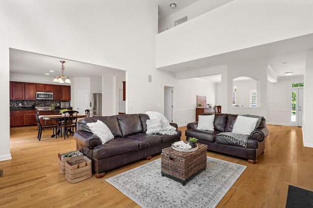 1201 Banbury Row, Brentwood, TN 37027 - living area with light wood-type flooring, baseboards, a chandelier, and a towering ceiling