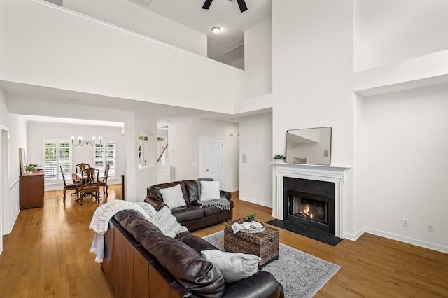 1201 Banbury Row, Brentwood, TN 37027 - living area with wood finished floors, a chandelier, a fireplace with flush hearth, stairway, and ceiling fan