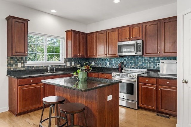 1201 Banbury Row, Brentwood, TN 37027 - kitchen featuring appliances with stainless steel finishes, a sink, light wood-type flooring, decorative backsplash, and recessed lighting