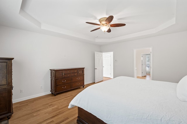 1201 Banbury Row, Brentwood, TN 37027 - bedroom with a tray ceiling, light wood-style floors, baseboards, and ceiling fan